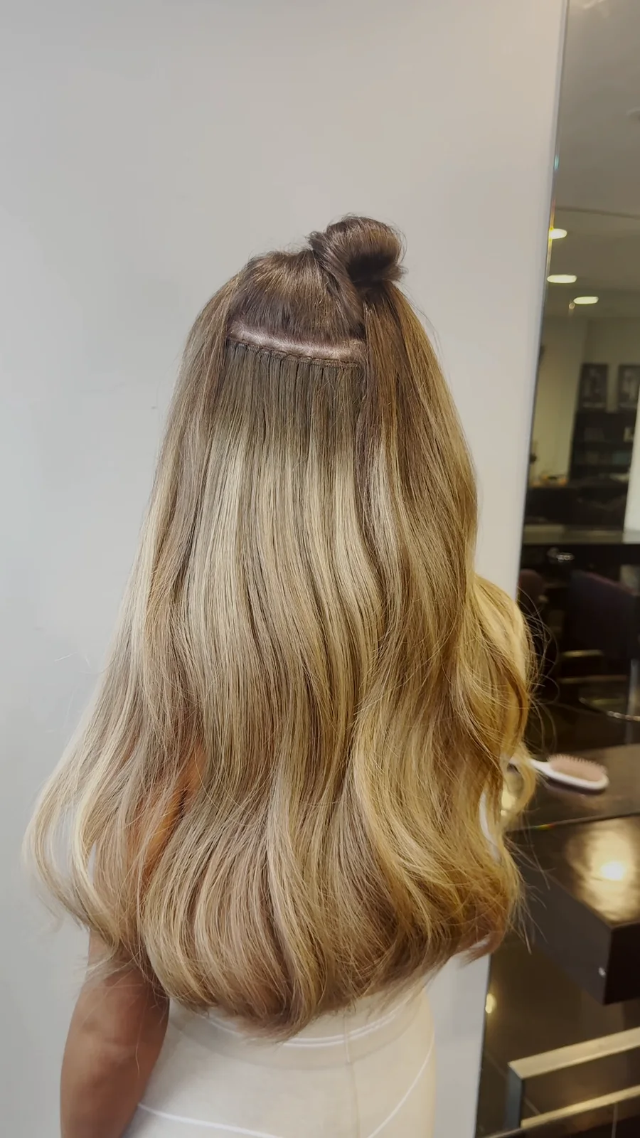 Long blended blonde weft extensions, finished in soft waves